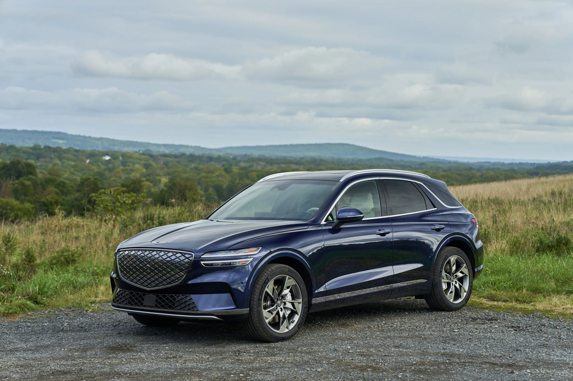 genesis electrified gv70 parked near a field