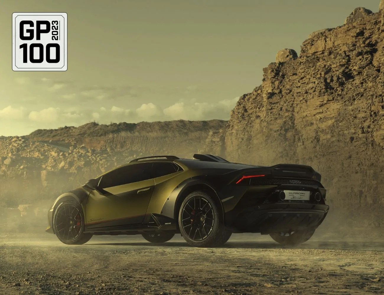 a black sports car parked on a road with rocky hills in the background