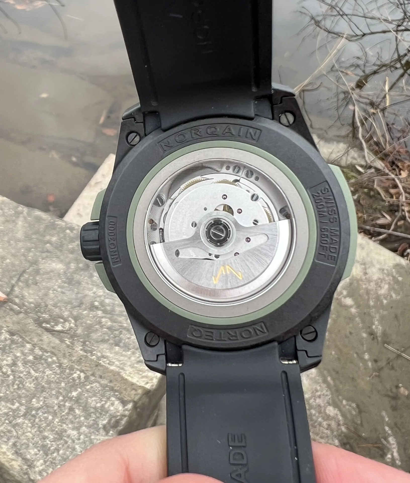 a hand holding a black watch