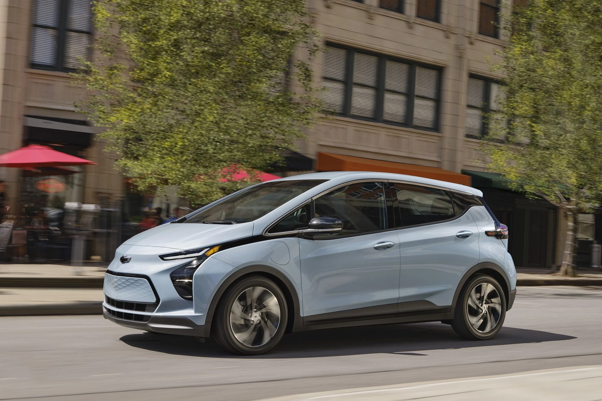 2023 bolt ev side profile while driving on an urban city street