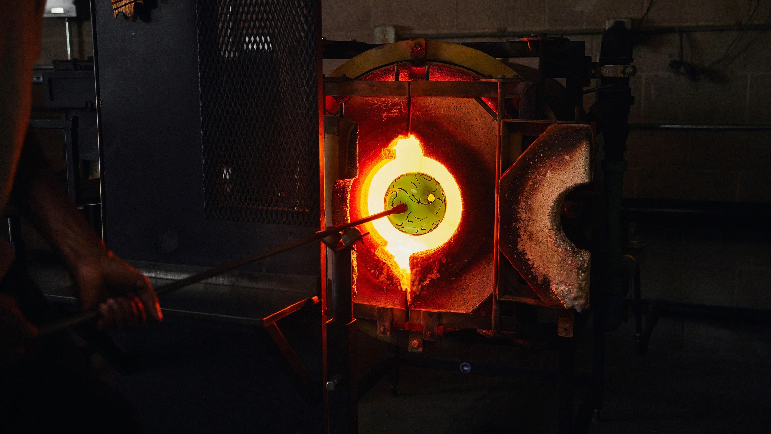 Cedric Mitchell heating up glass in the furnace