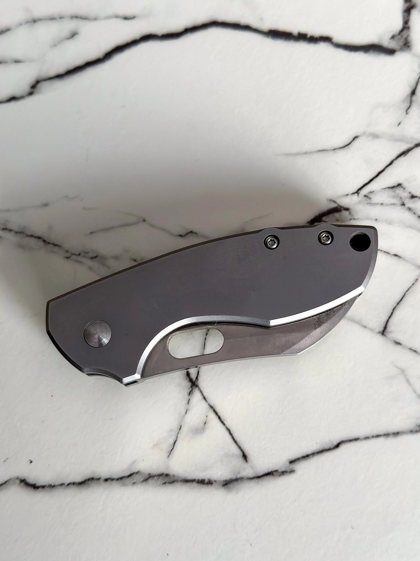 a silver knife on a marble counter
