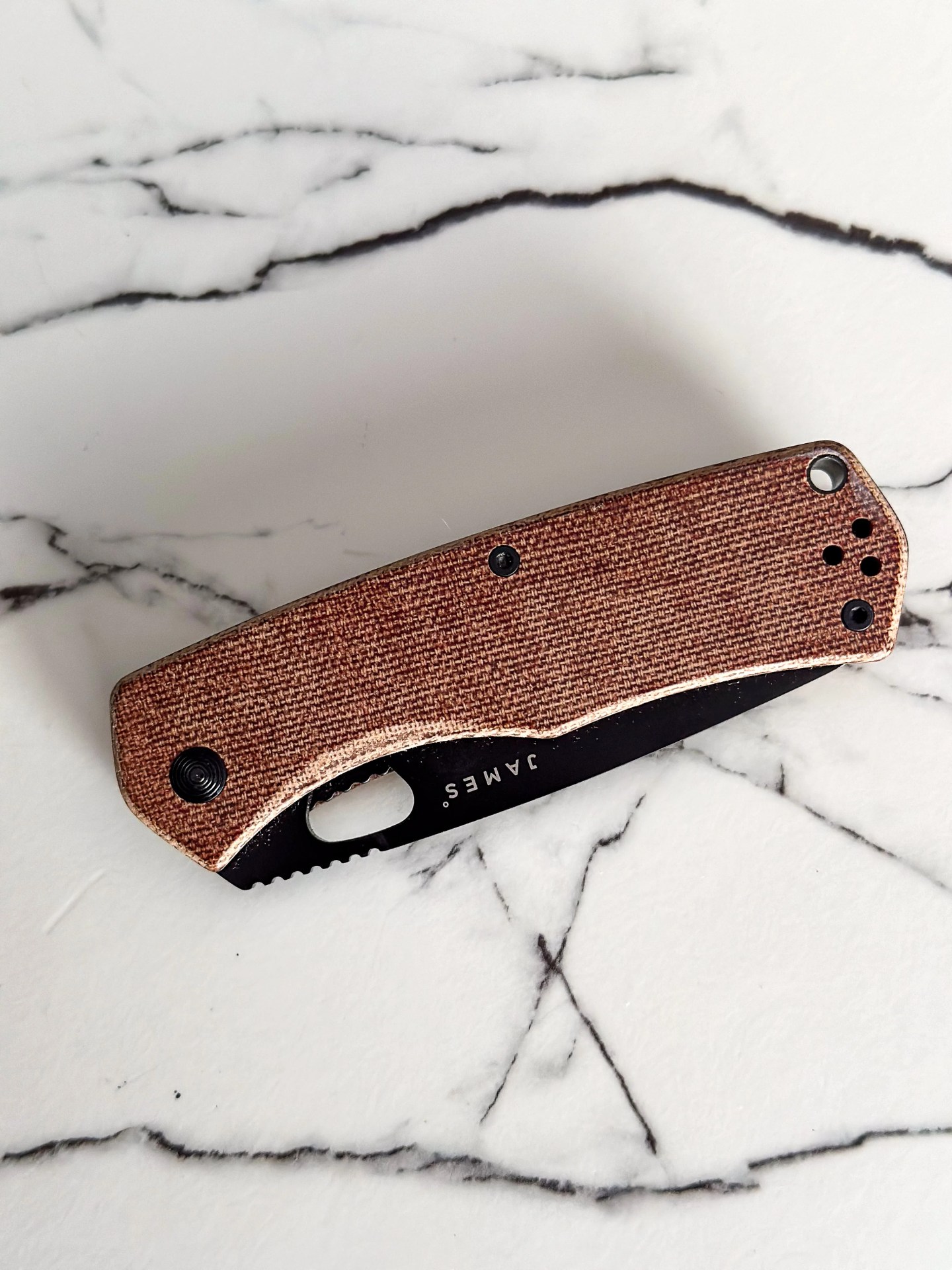 a brown knife on a marble counter
