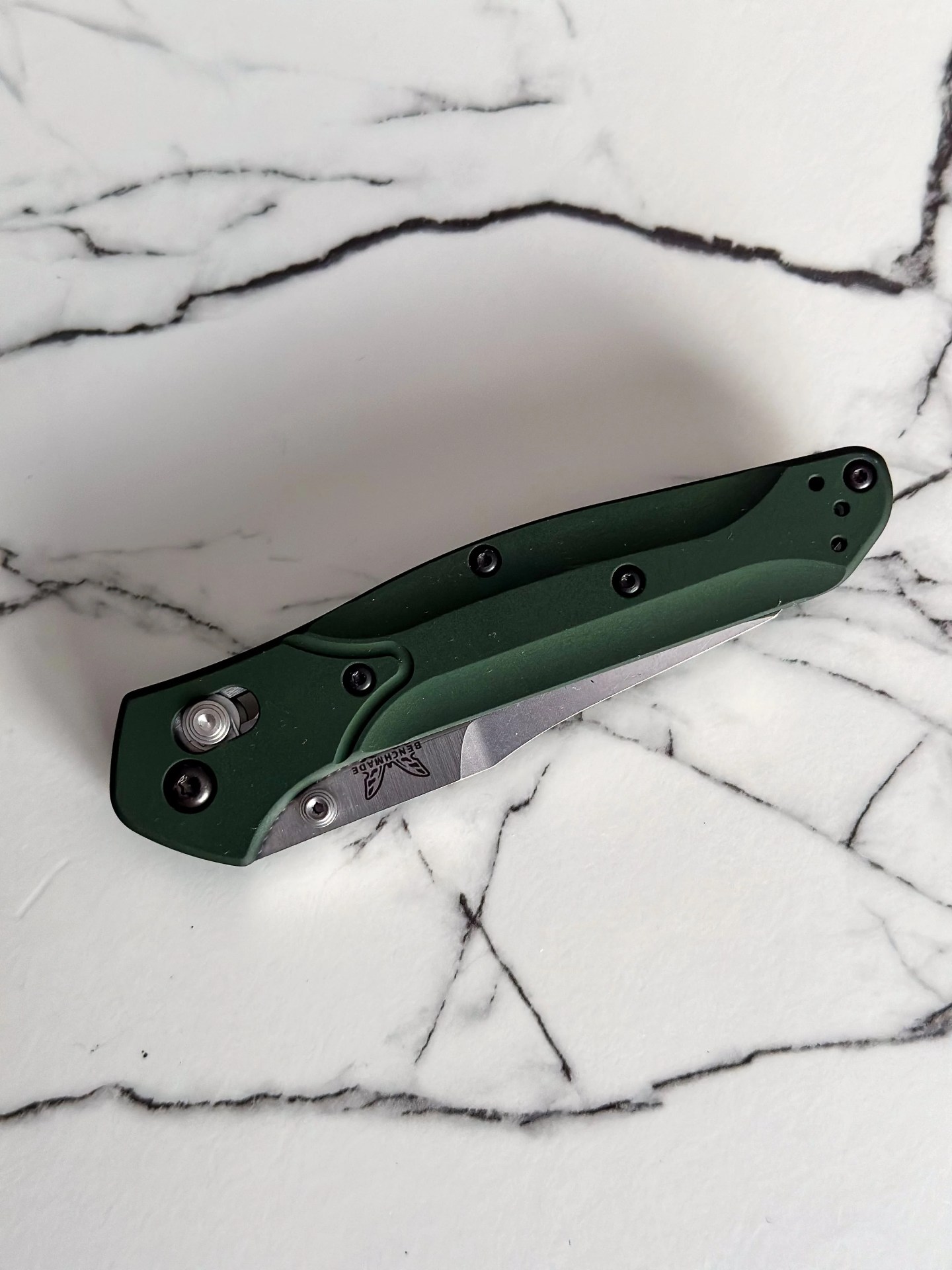 a green knife on a marble counter