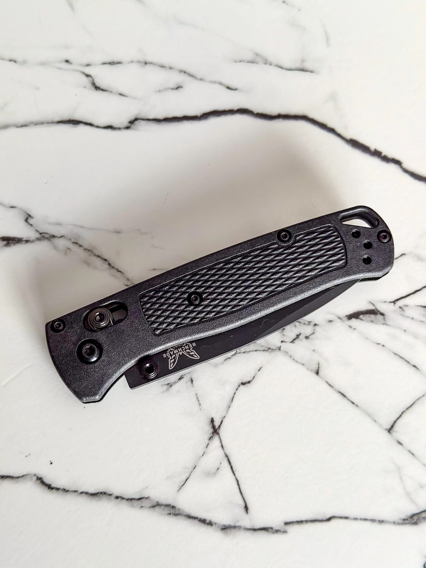a black knife on a marble counter