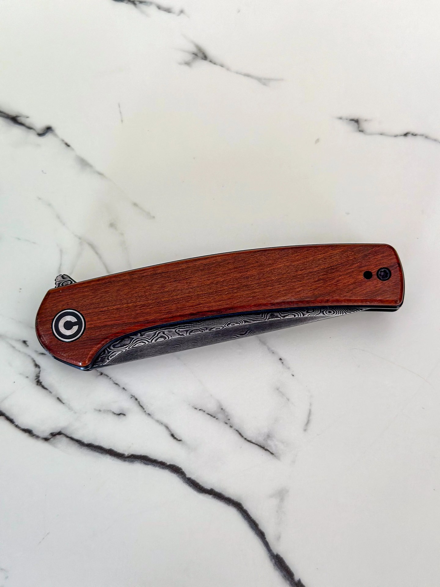 a brown knife on a marble counter