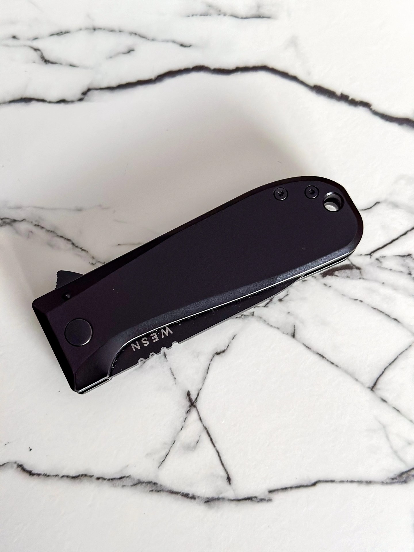 a black knife on a marble counter