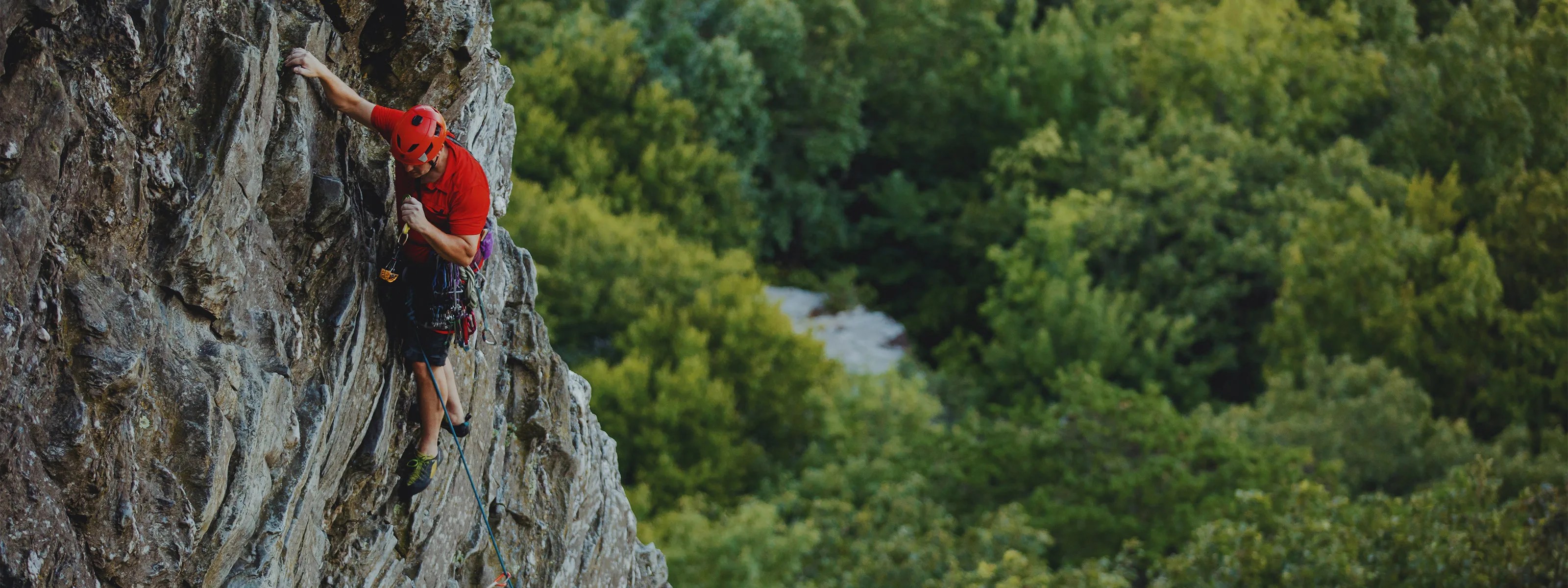 man climbing Moore's Wall Hanging Rock State Park