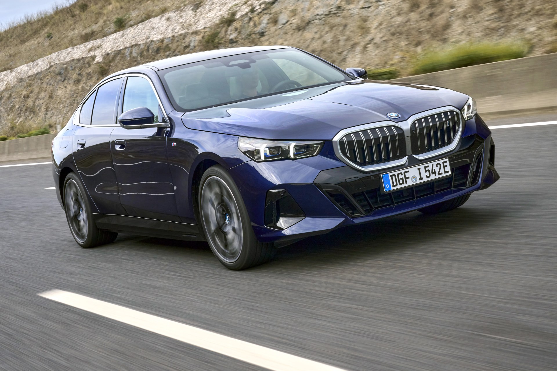 the bmw i5 driving at you on a road