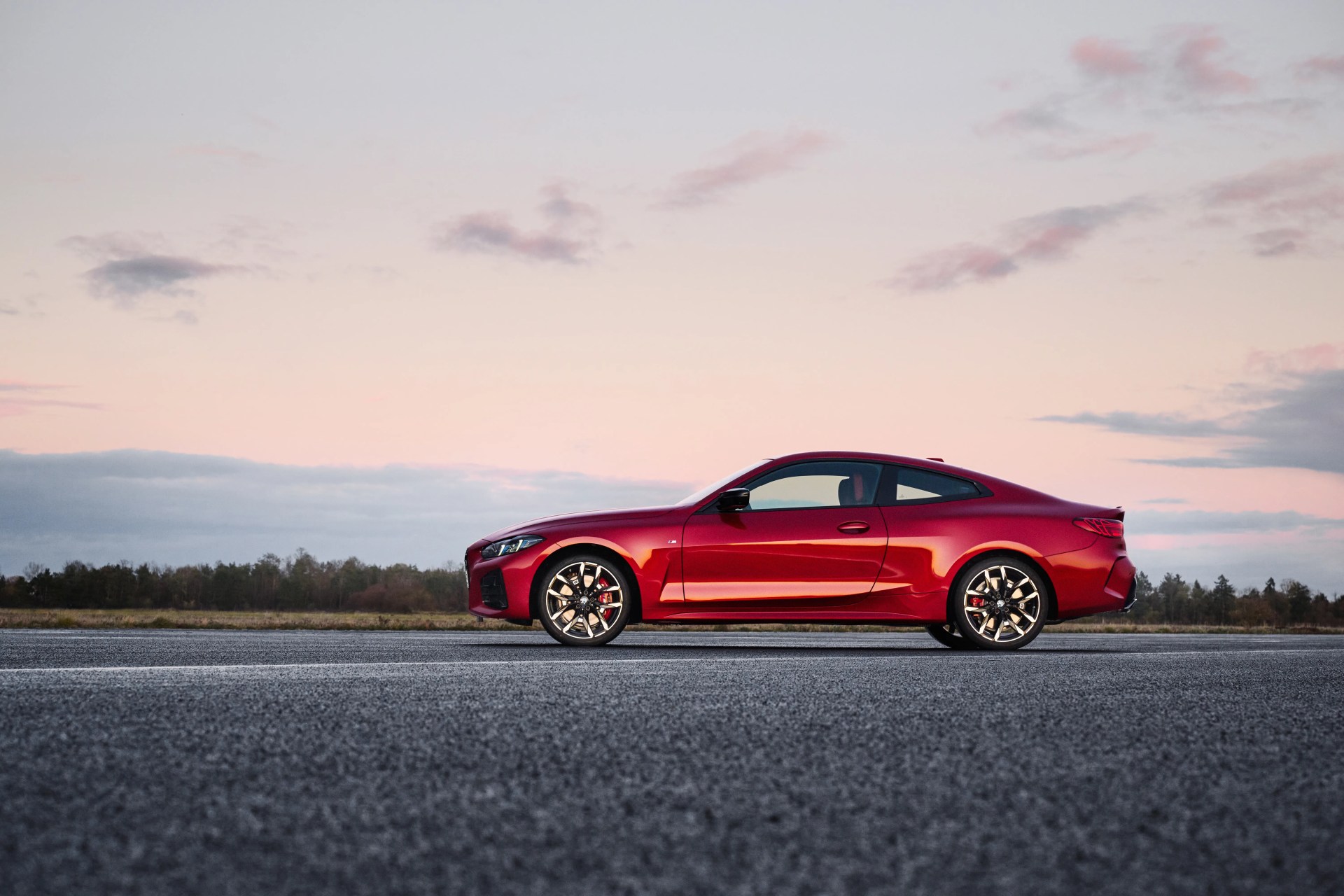 red bmw 4 series coupe seen from the side