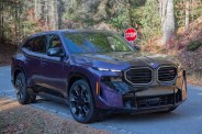 a purple 2024 bmw xm label front three quarter view