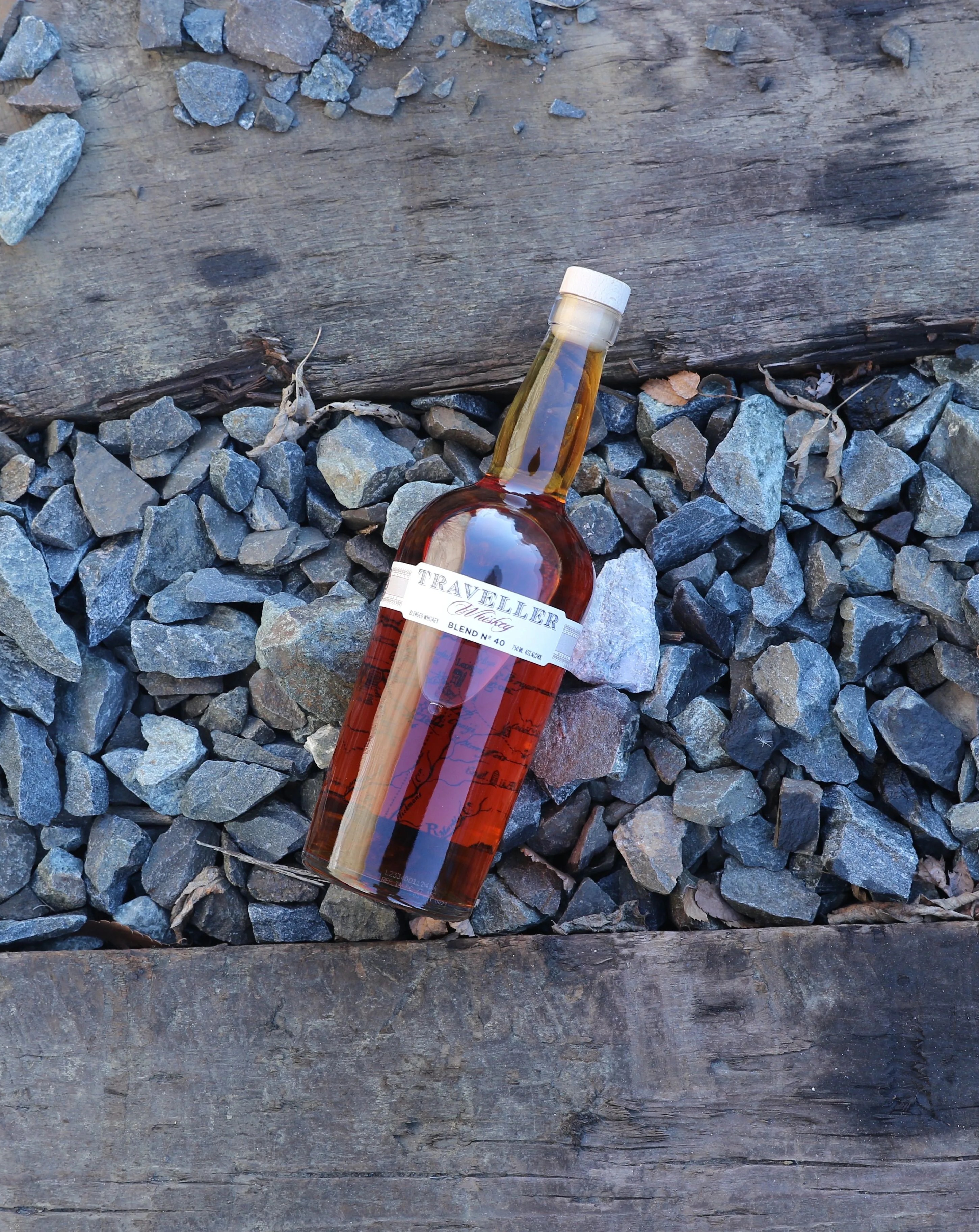 bottle of whiskey on train tracks