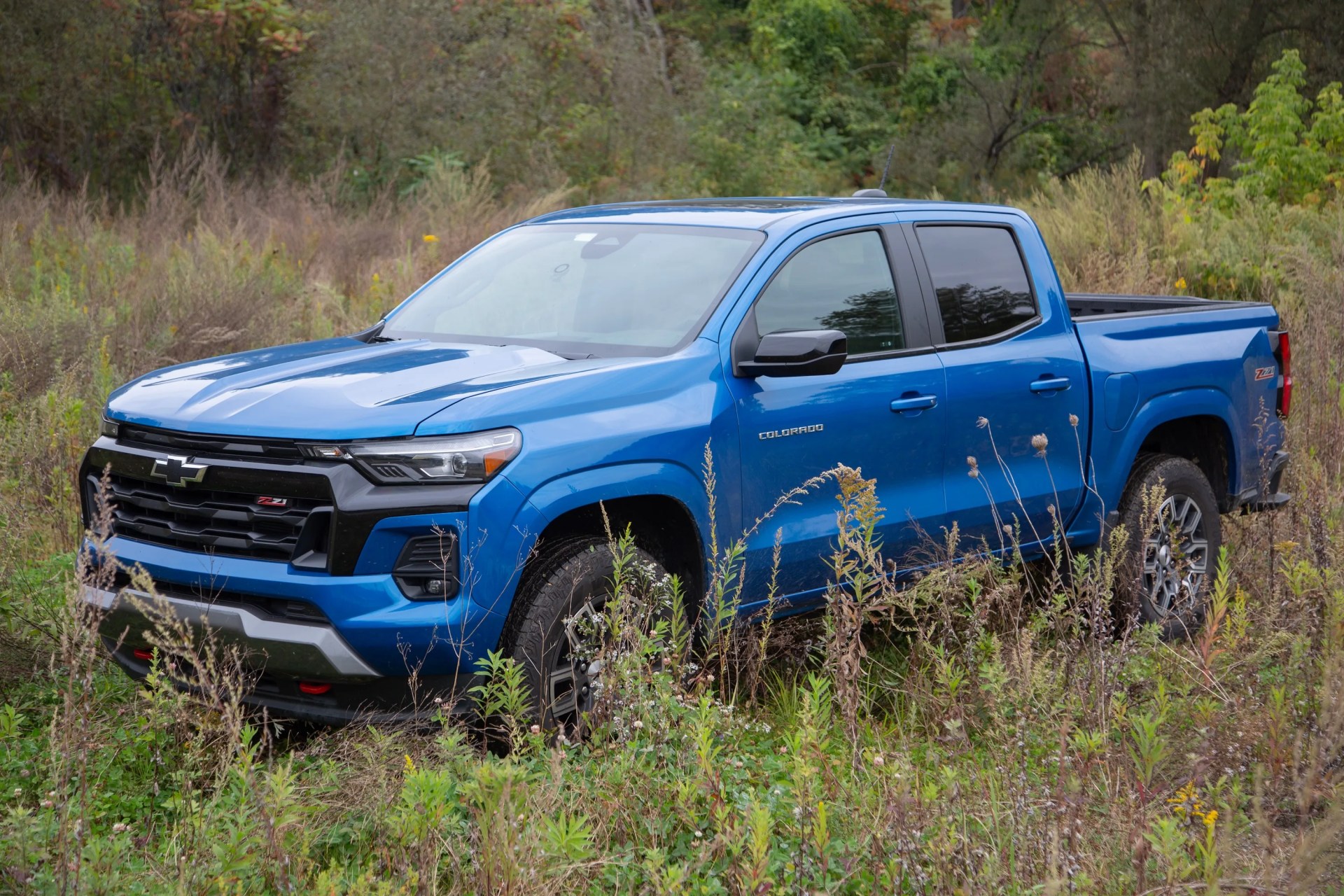 chevrolet colorado pickup truck in blue in a meadow