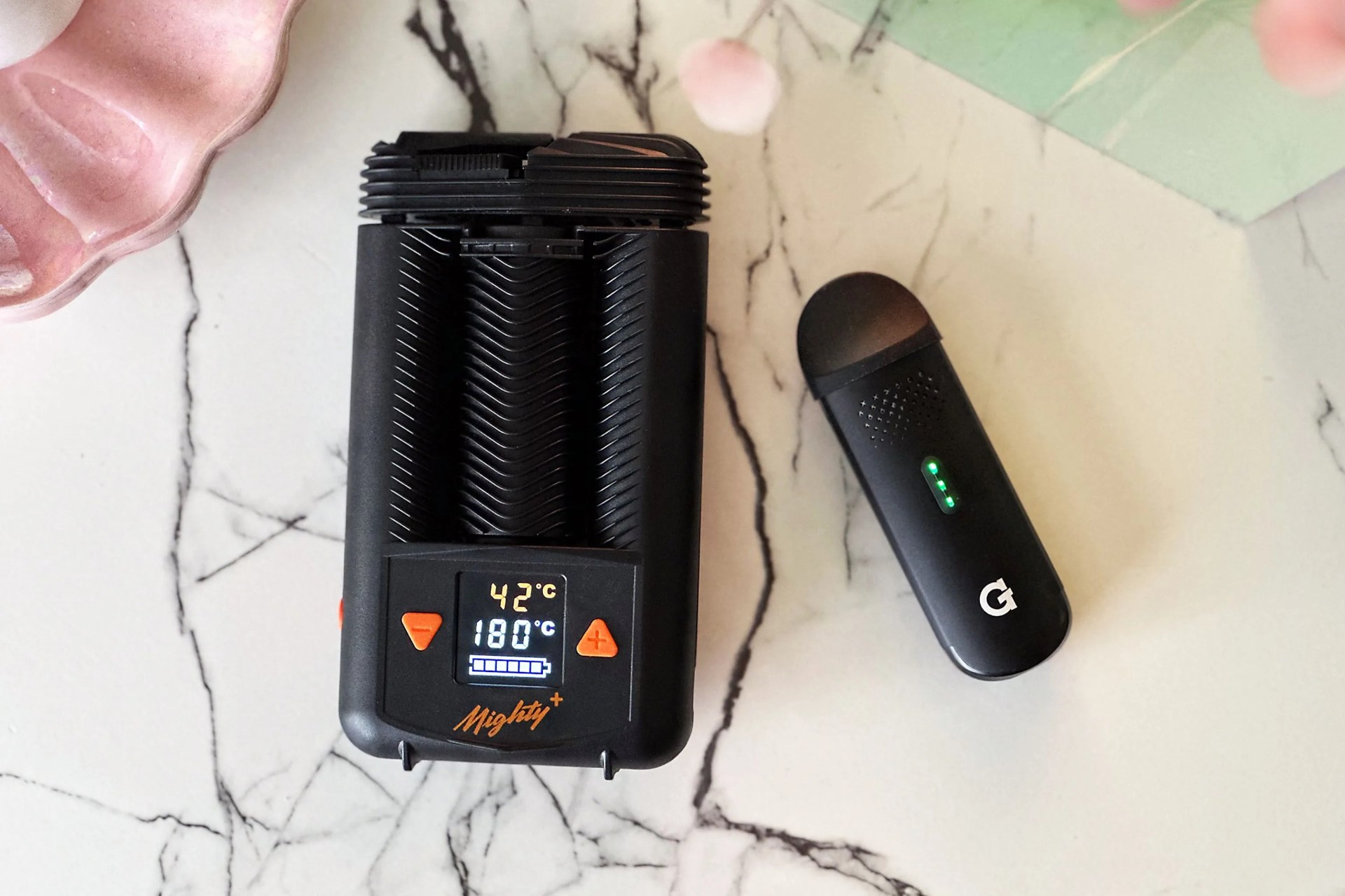 two weed vapes on a counter next to each other