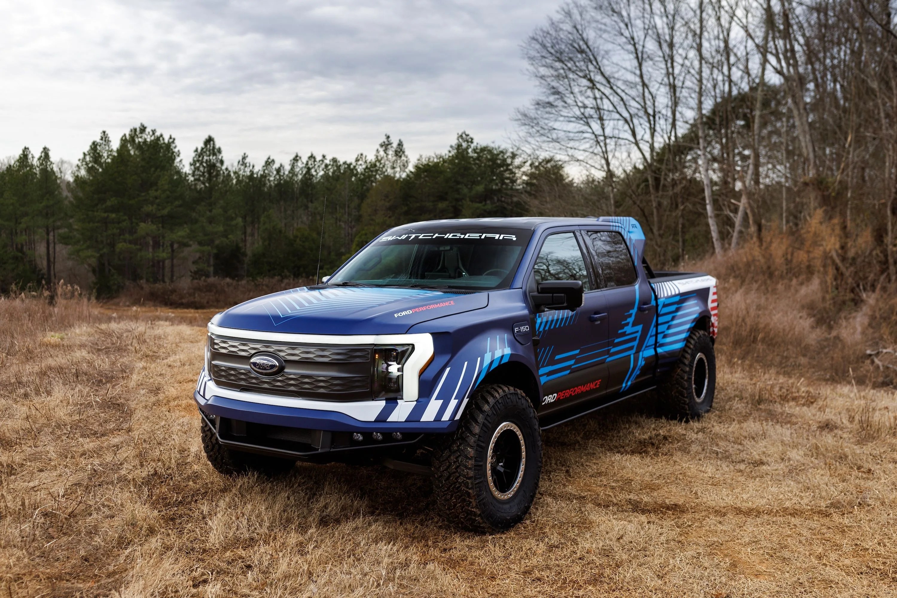 a blue truck on a dirt road