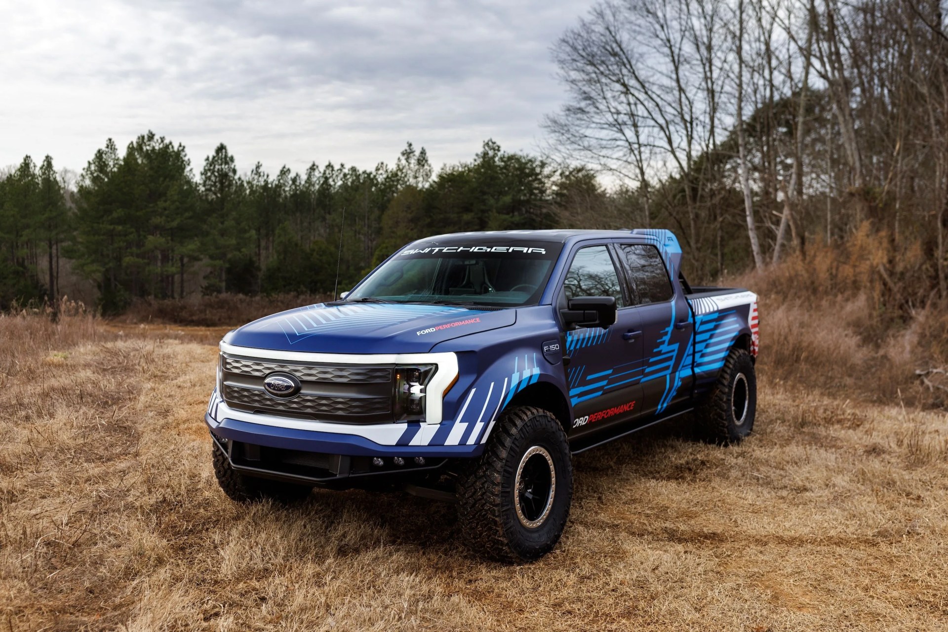 a blue truck on a dirt road