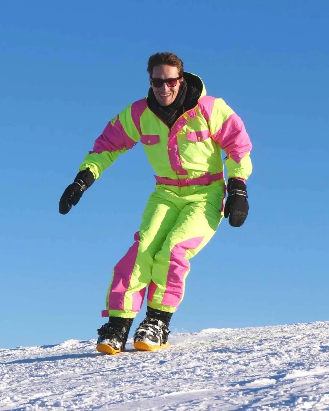 a man wearing a colorful snow suit and snowfeet skiblades