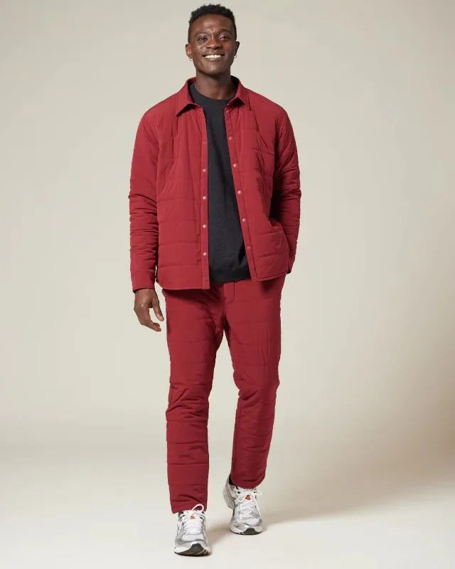 a man wearing a snow peak red flexible insulated shirt