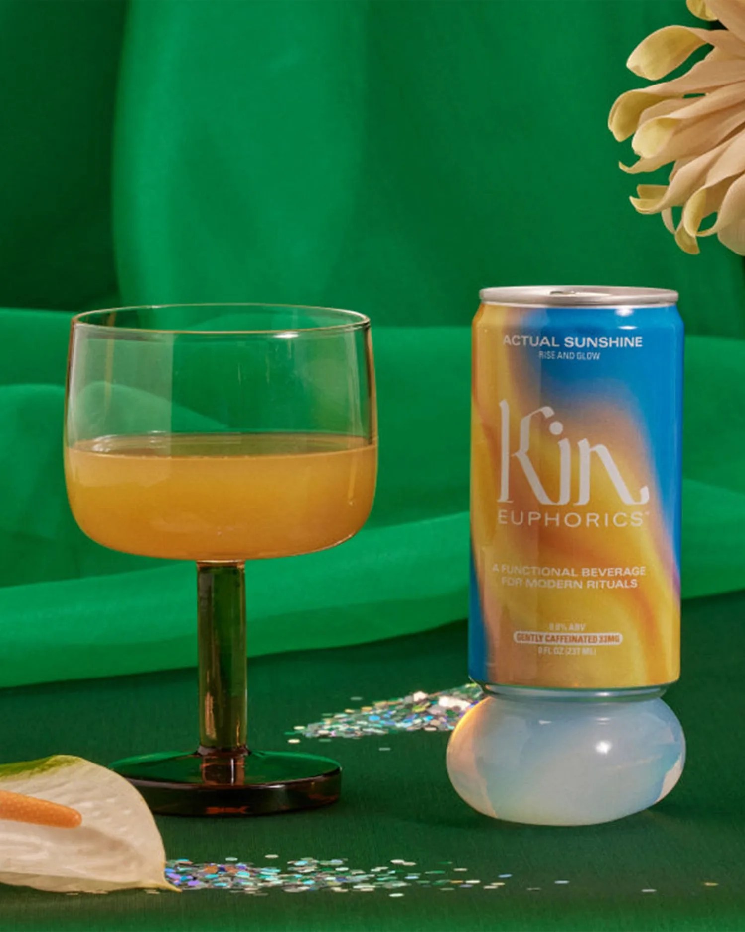 a cocktail on a table next to a can