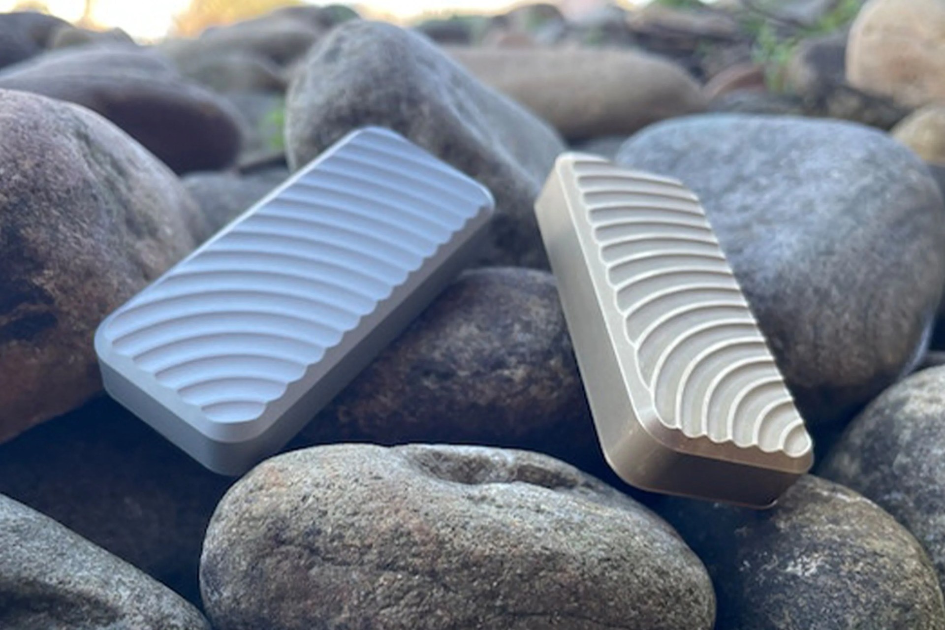 two textured utility knives sitting on rocks