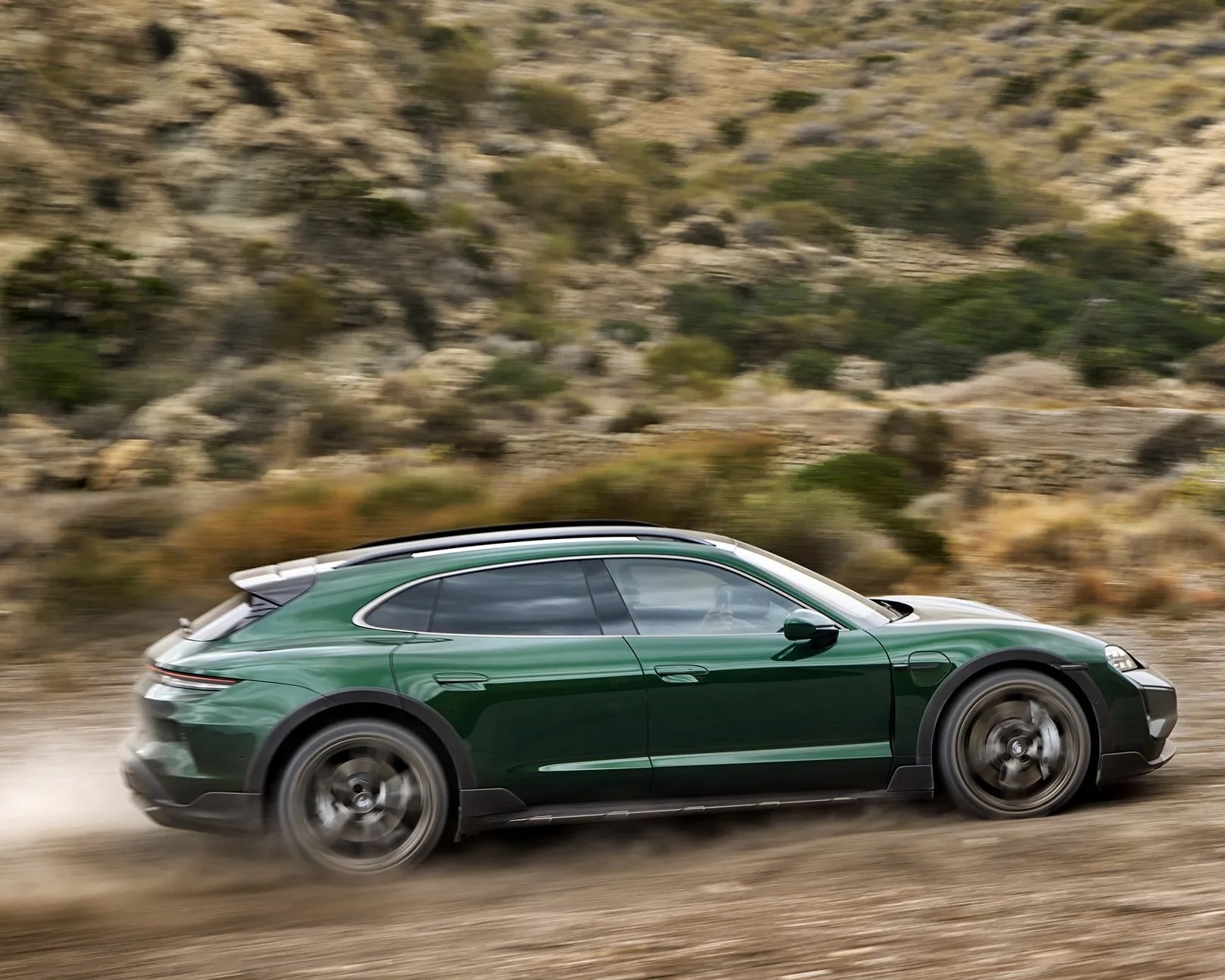 green porsche taycan cross turismo driving off road