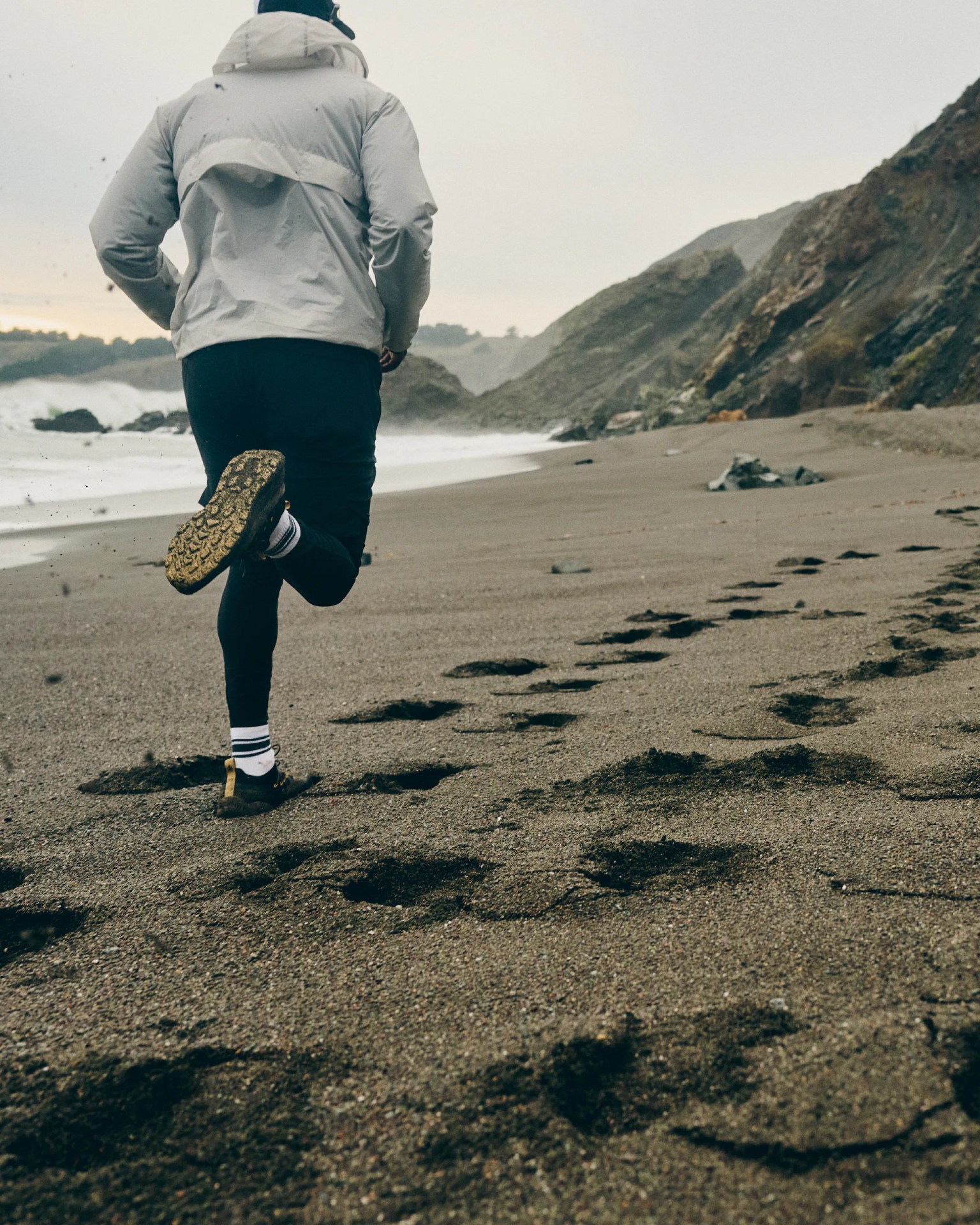 man jogging on beach wearing Naglev Veloce Kevlar Trail Running Shoe in Black