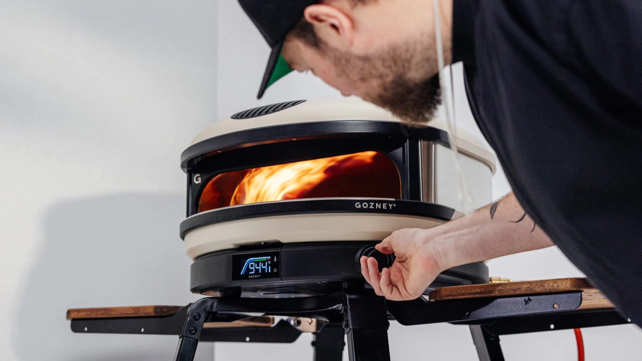 man using Gozney arc fire place
