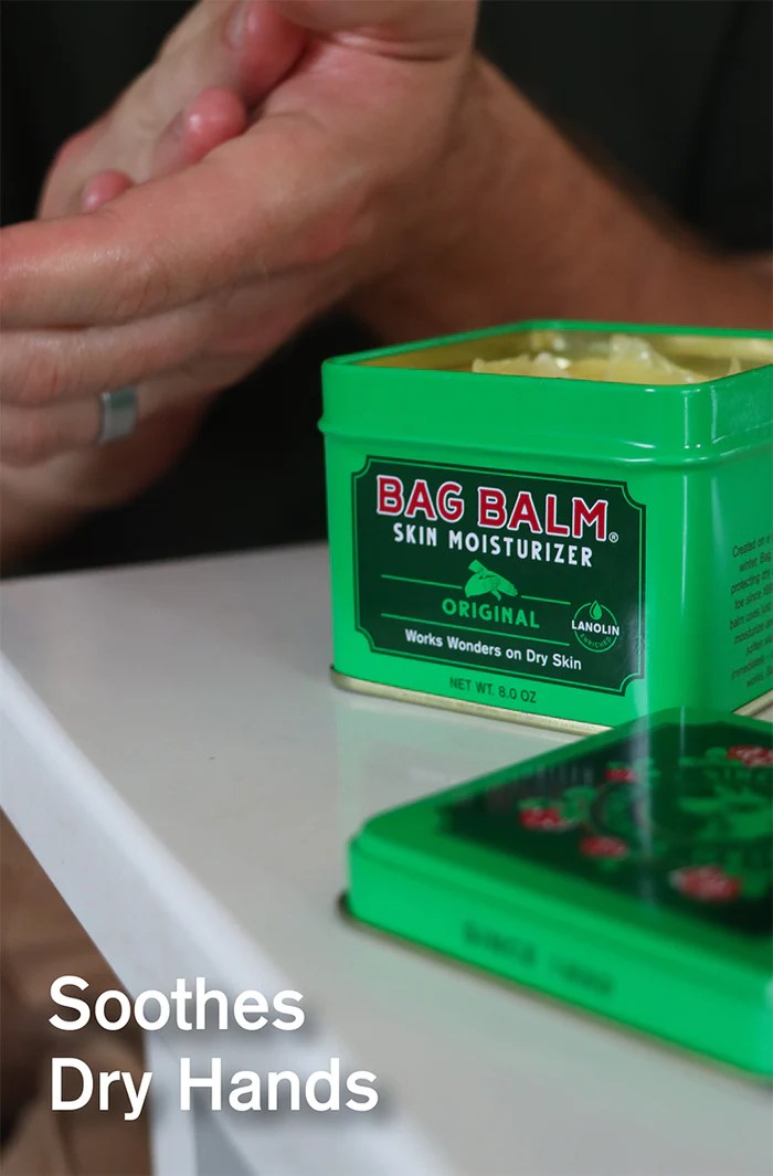 person moisturizing their hands using bag balm