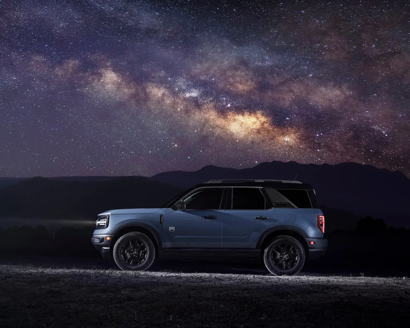 side view of ford bronco sport at night under a starry sky
