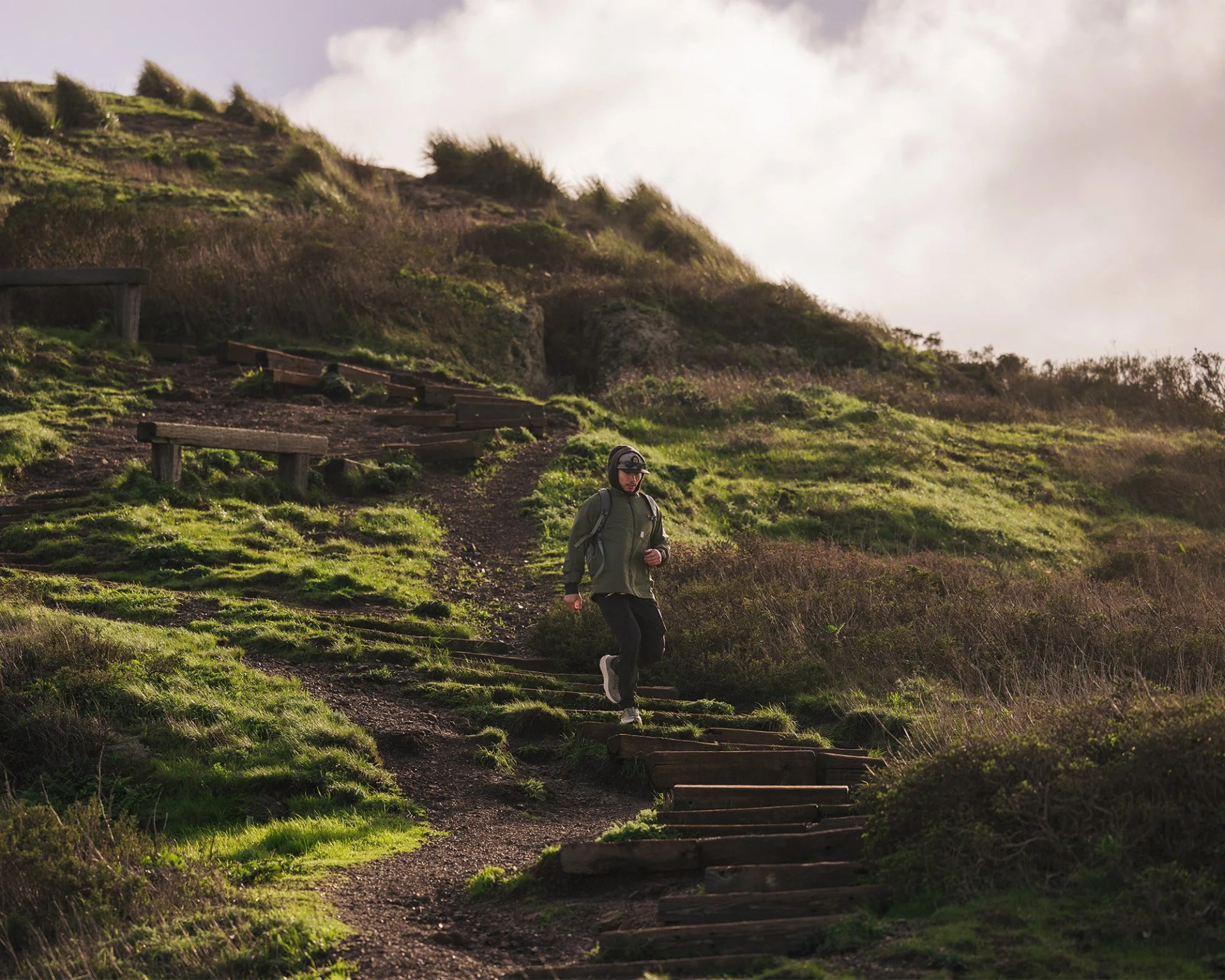 Daniel He running down slope wearing HOKA sneakers