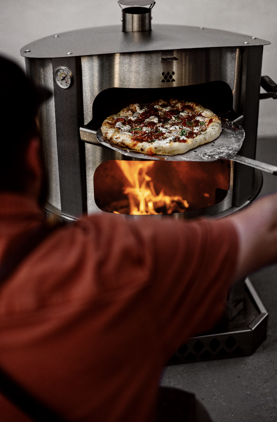 breeo live fire pizza oven in use