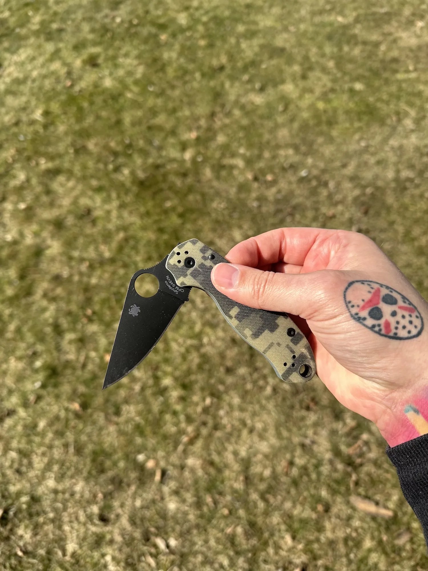 hand holding pocket knife partially open