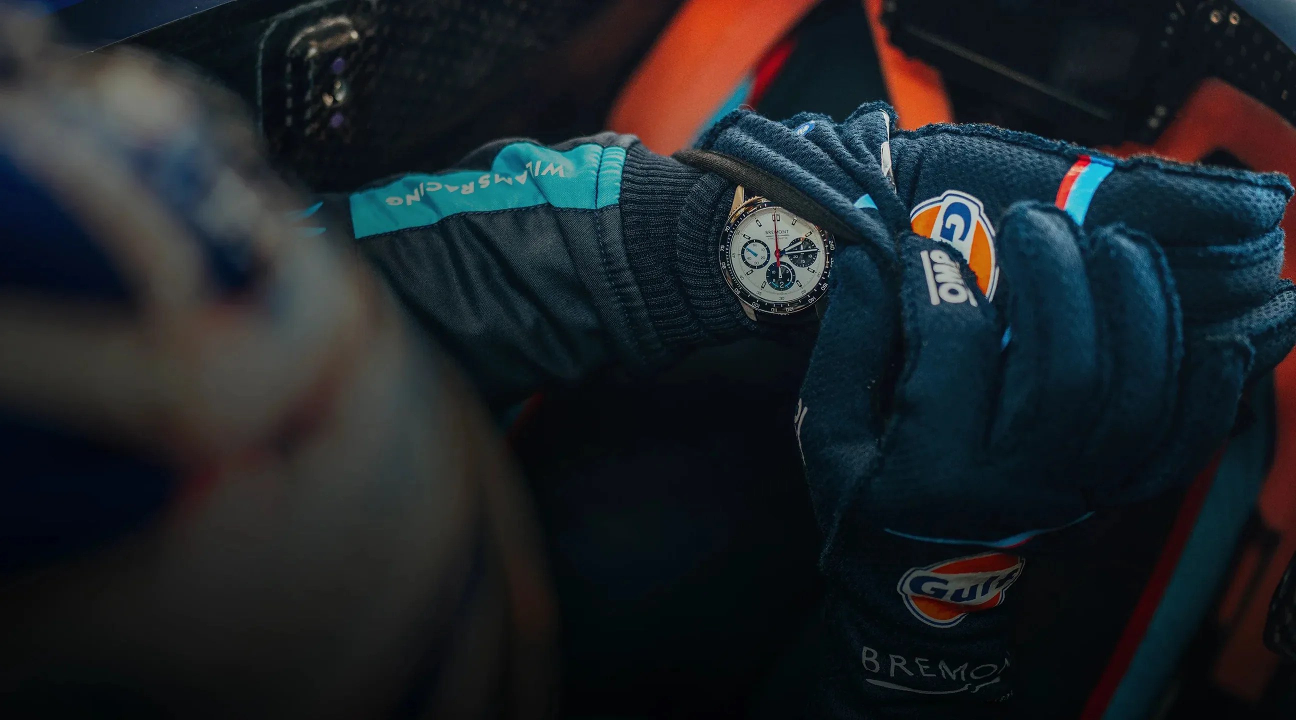 racecar driver looks at watch on wrist