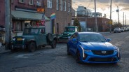 a blue blue cadillac ct4 v blackwing parked on a cobblestone street in brooklyn