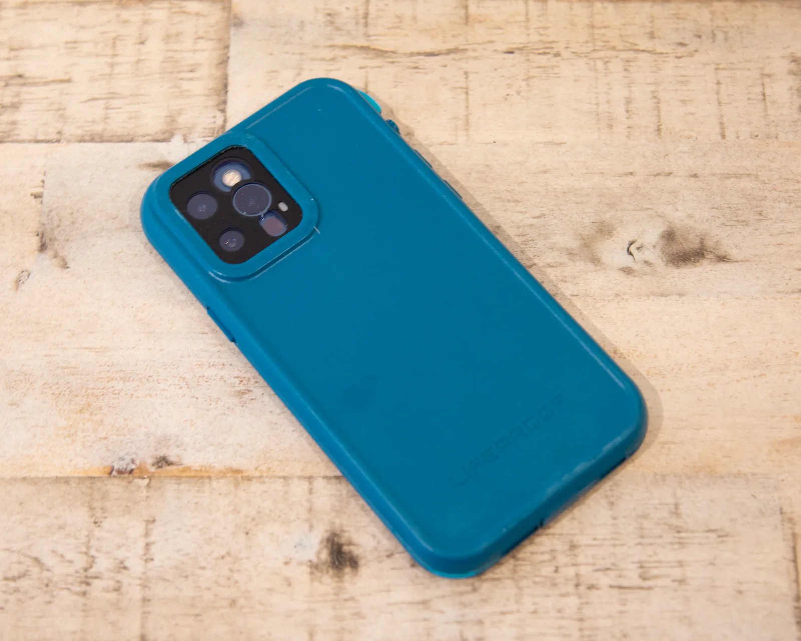 rear of a green otterbox lifeproof fre case on an iphone 12 pro