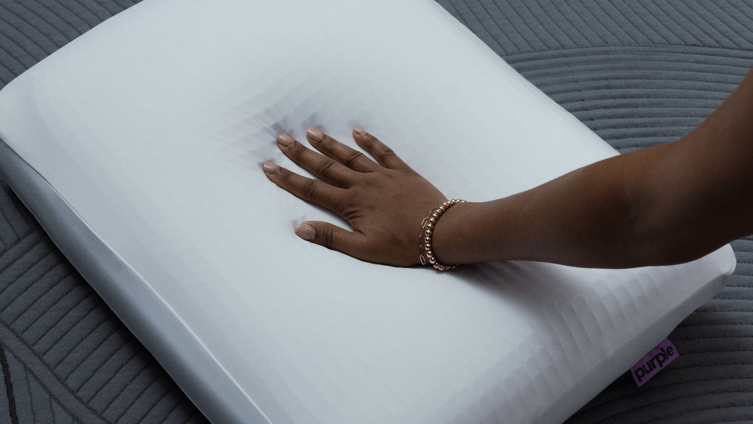 hand resting on Purple DreamLayer™ Pillow