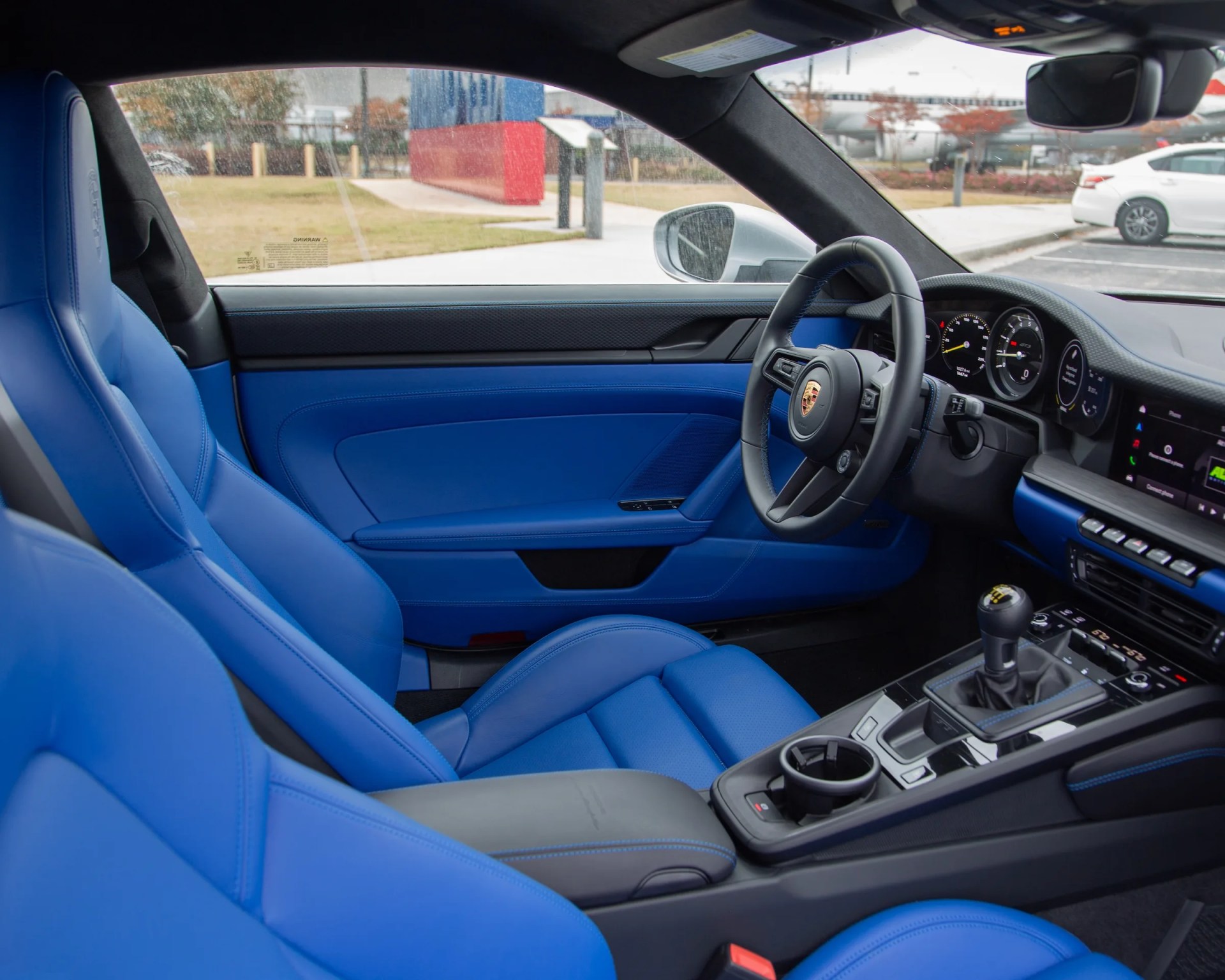 the bright blue interior of a porsche 911 gt3 touring
