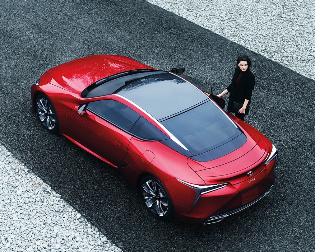 Lexus LC 500 with woman entering right side. 