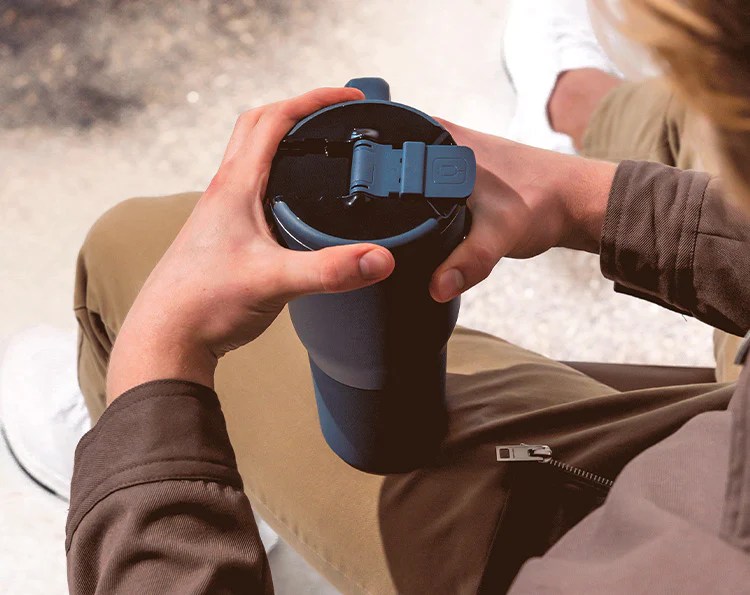 person holding BrüMate New! Müv 35oz tumbler