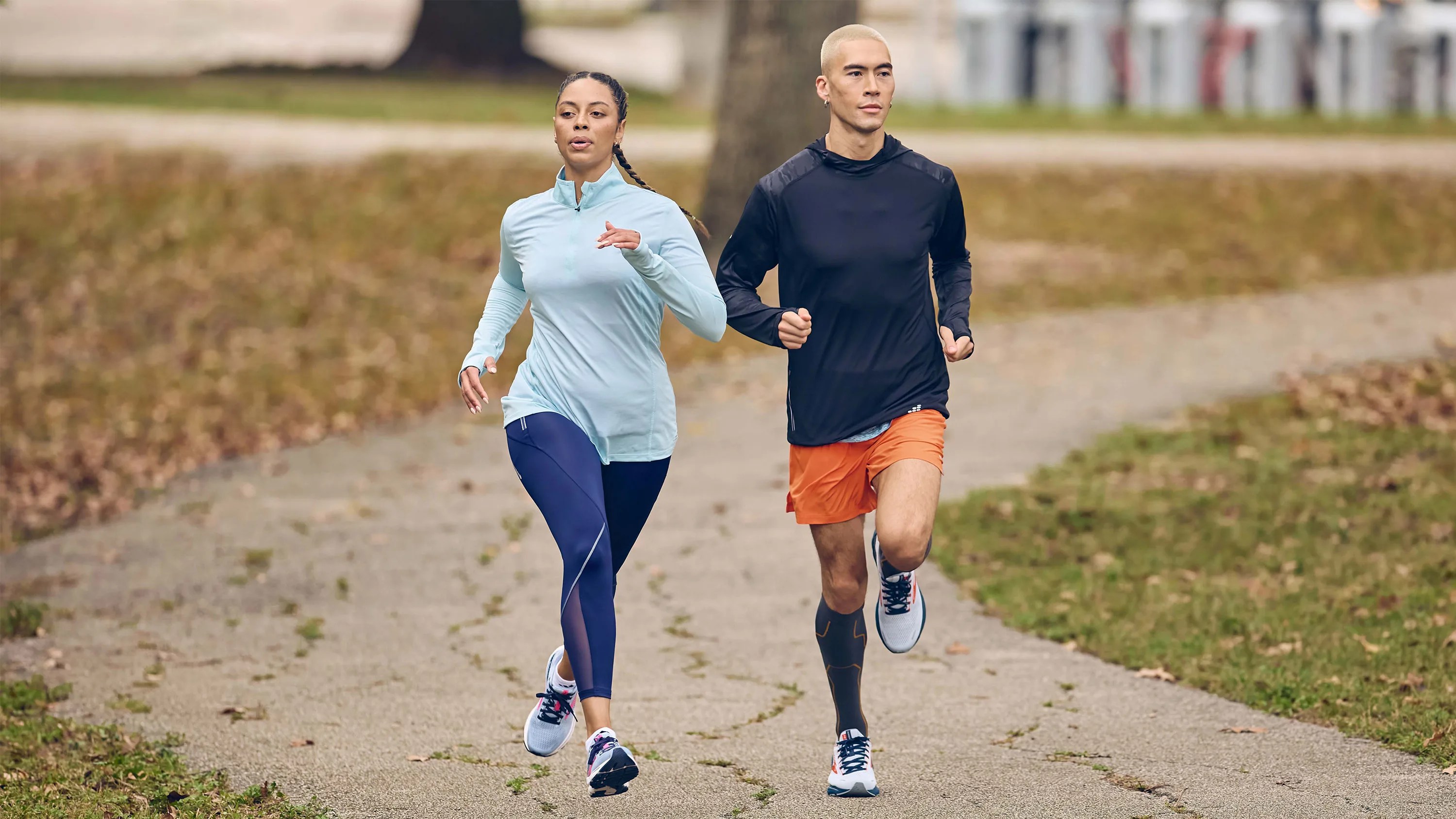 man and woman jogging on path wearing Academy Sports + Outdoors sneakers