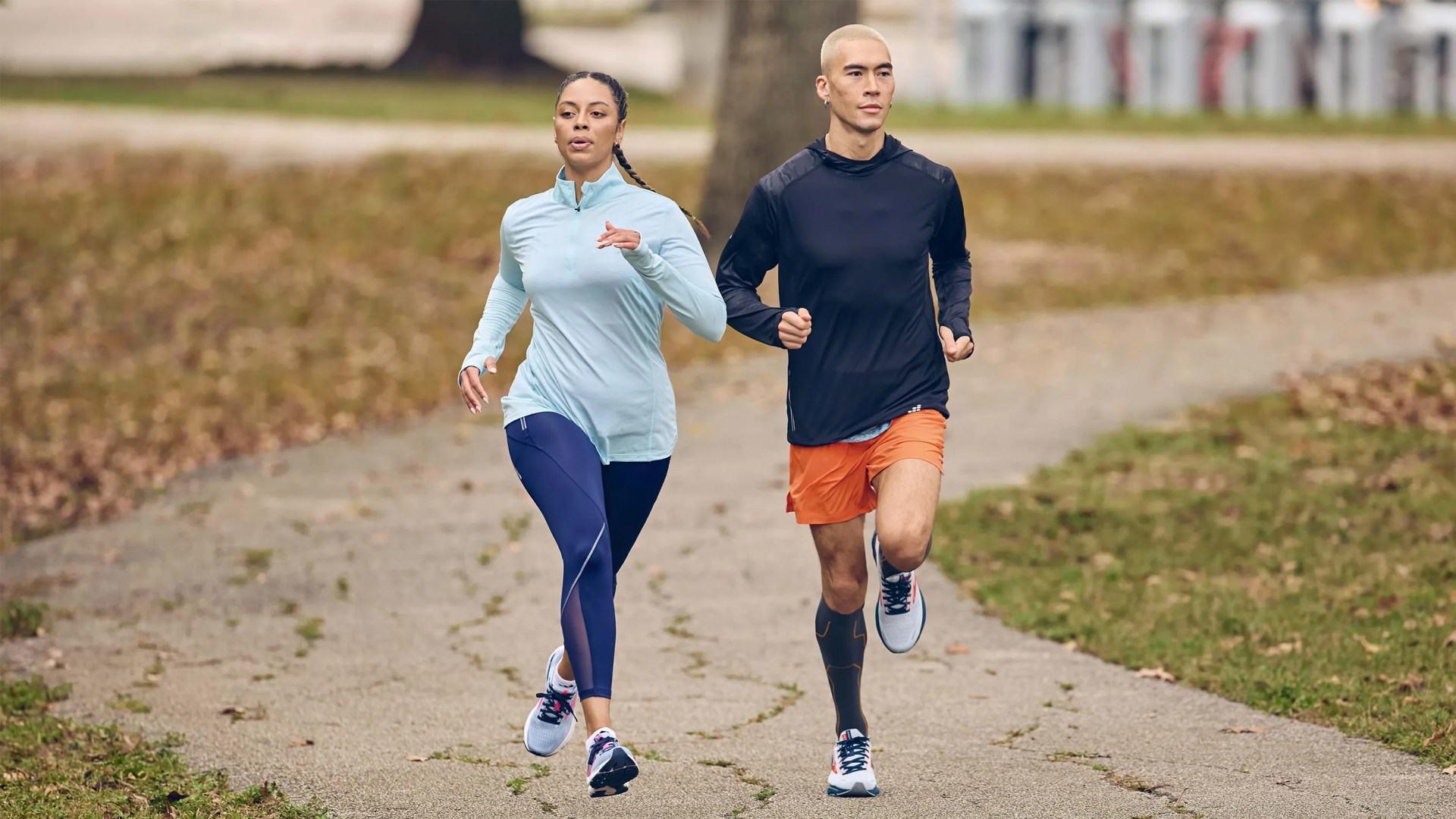 man and woman jogging on path wearing Academy Sports + Outdoors sneakers