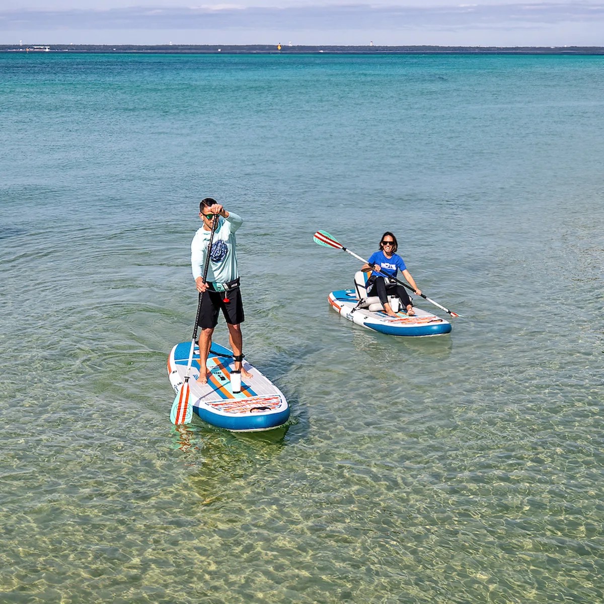 man and woman stand up paddle boarding on BOTE paddle boards
