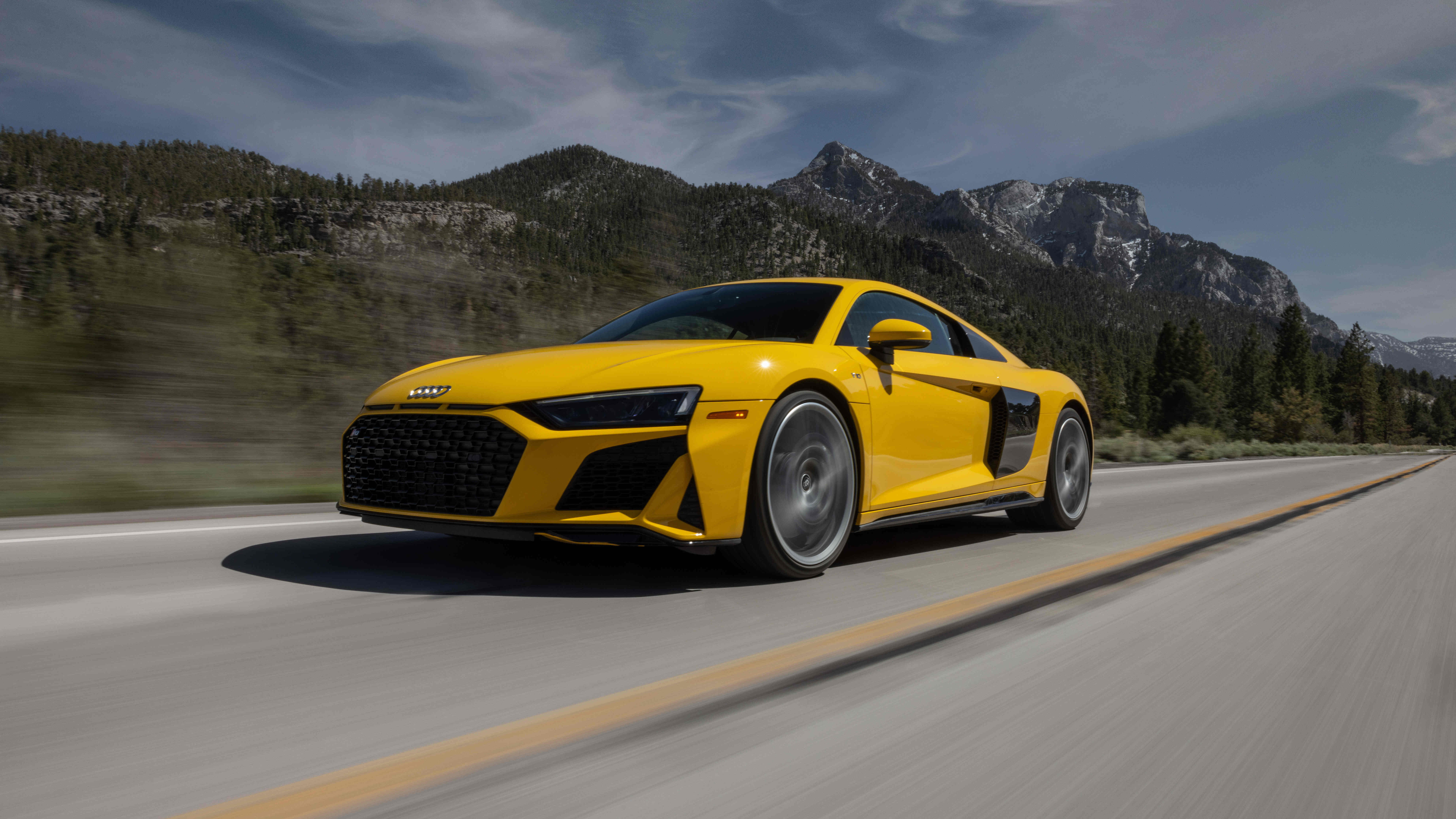 Audi R8 driving with mountains in background