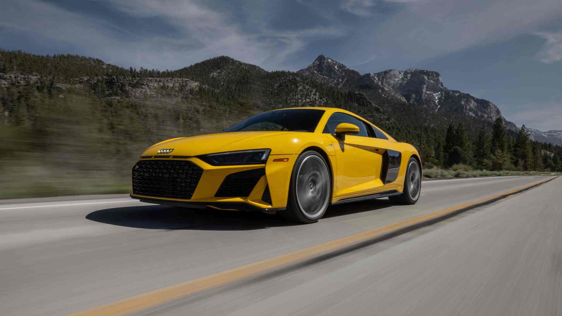 Audi R8 driving with mountains in background