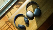 beats studio pro headphones next to apple airpods max headphones on a wooden table