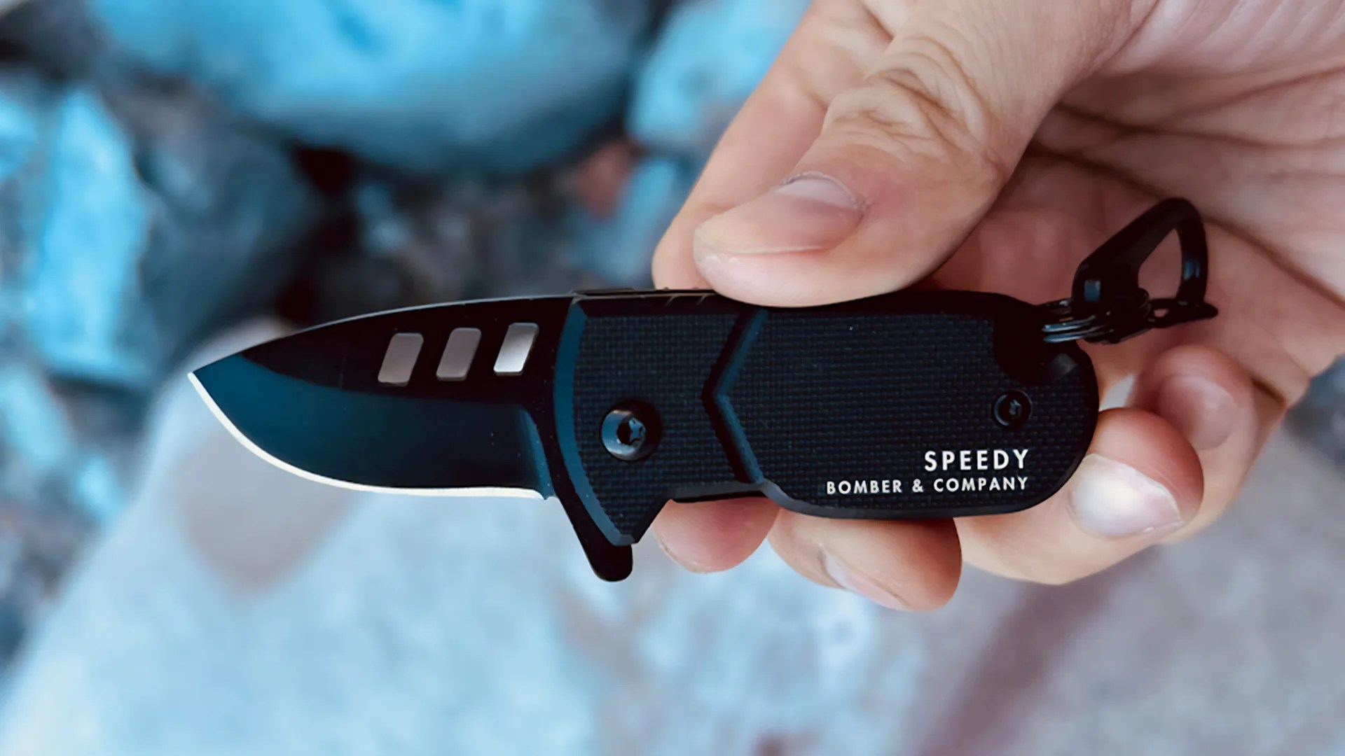 a persone holding a black Bomber and Company Speedy Mini Pocket Knife