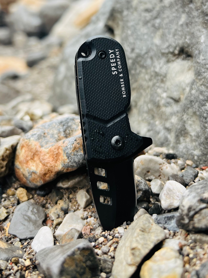 A small pocket knife with its blade in the dirt