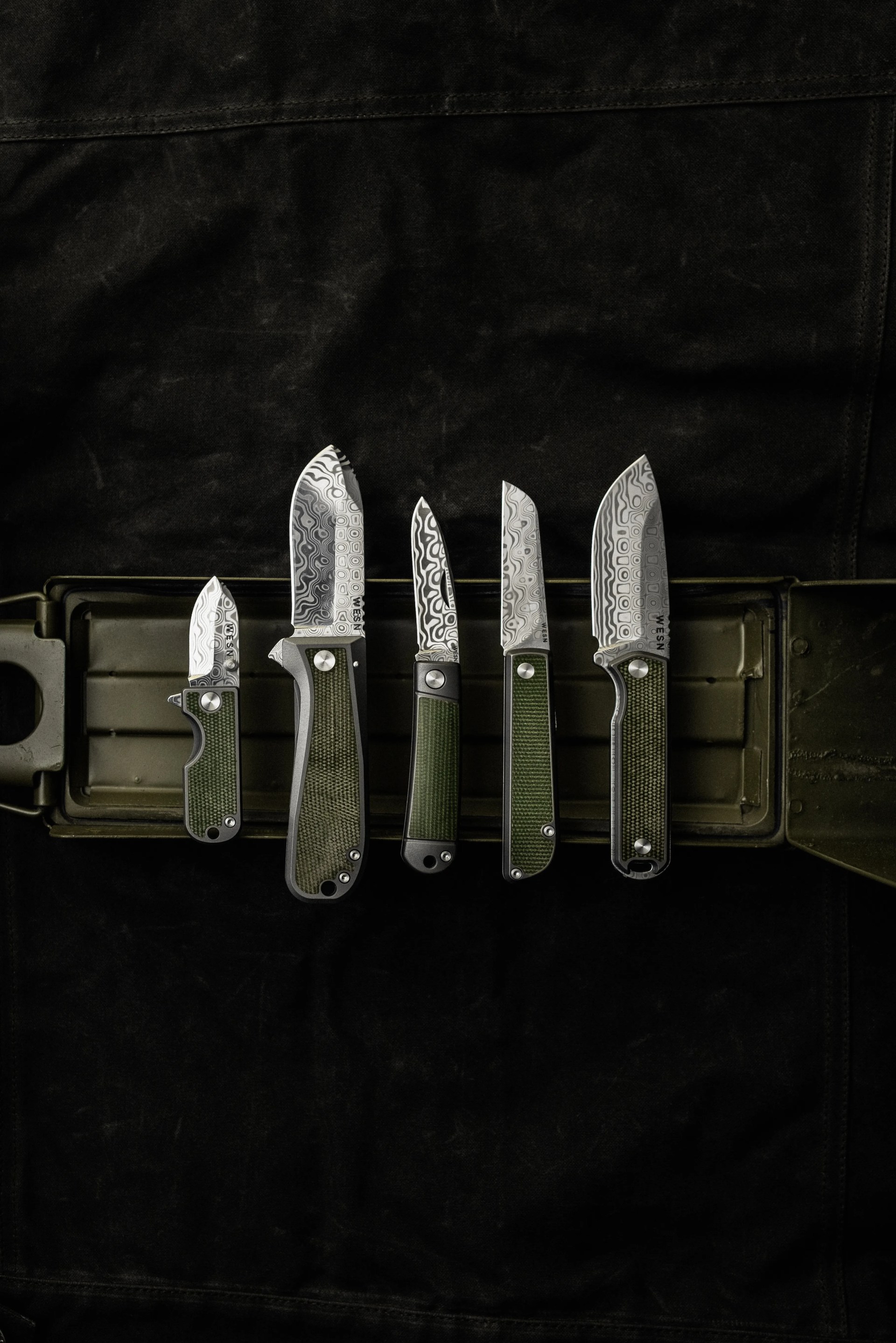 wesn founder's line knives on a green and black background
