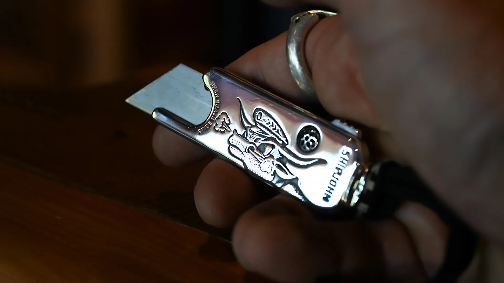 a person holding a Good Art x Ship John Little Cutter silver knife