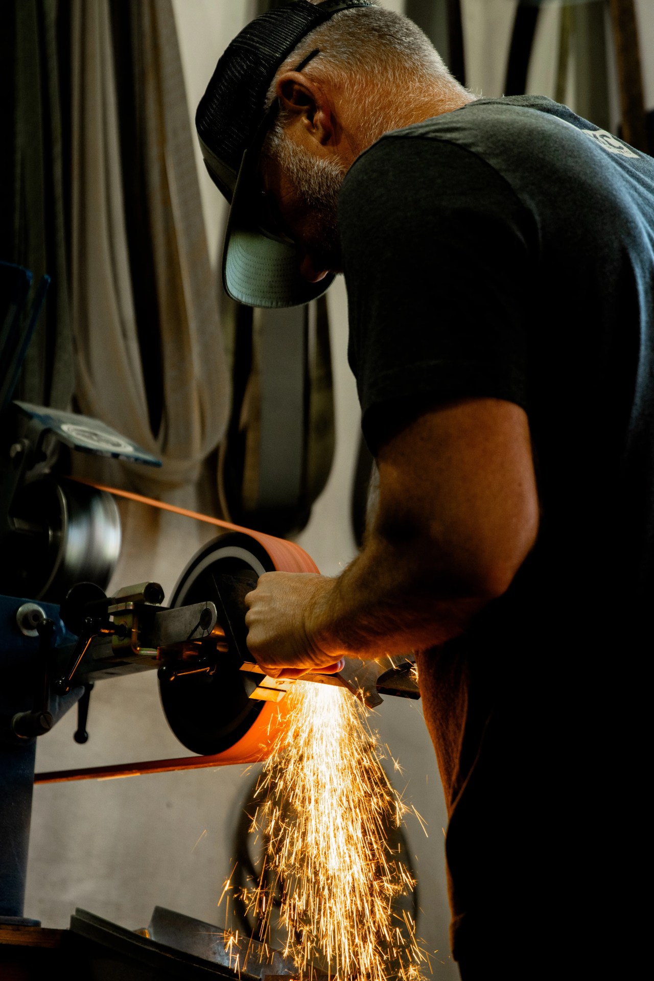 josh smith of montana knife company grinding a hatchet